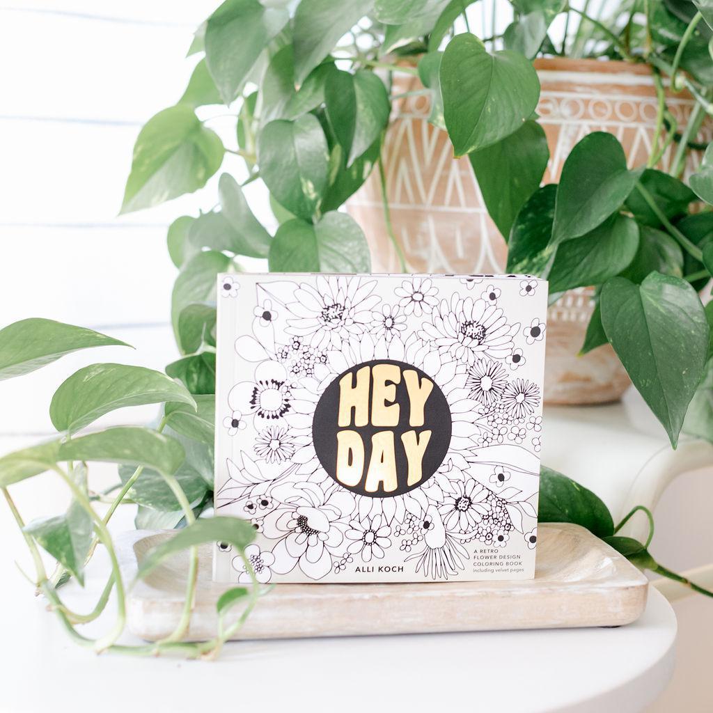 A mini coloring book with a black and white floral design and the text &
