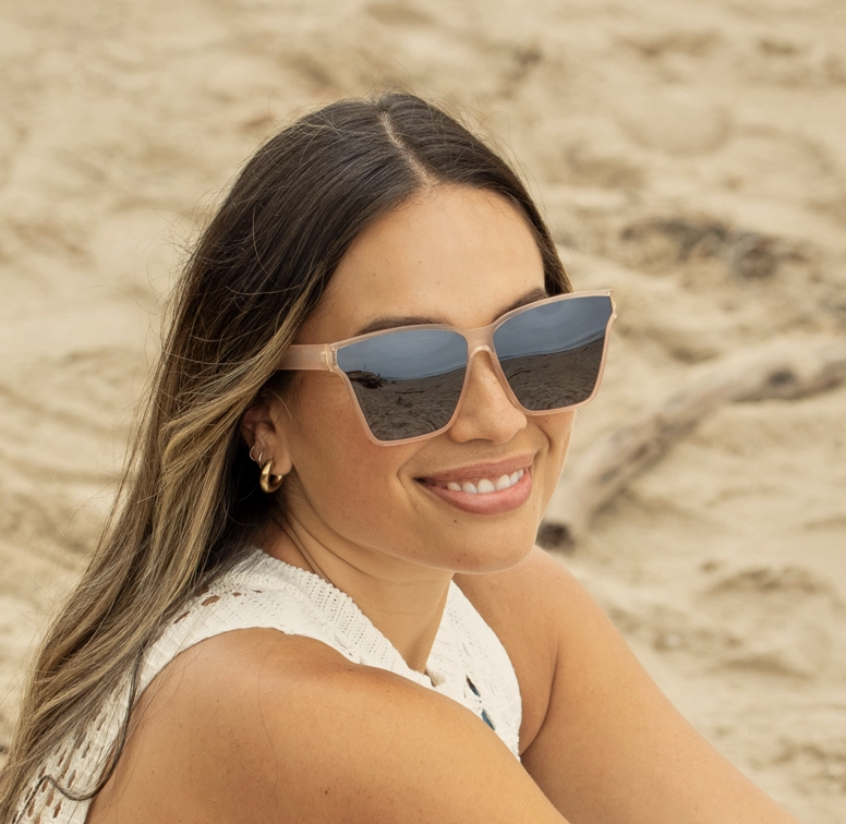 Woman wearing sunglasses on a sandy beach