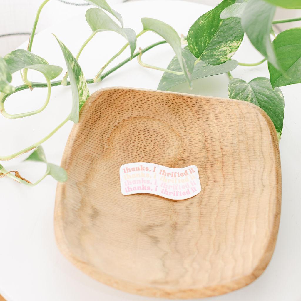 A wooden sticker with the text &