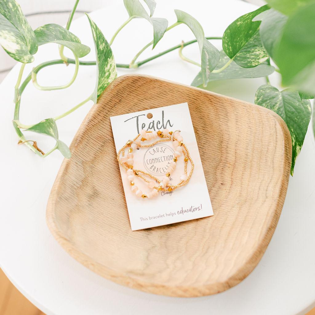 A wooden bracelet box with a cardboard holder labeled &