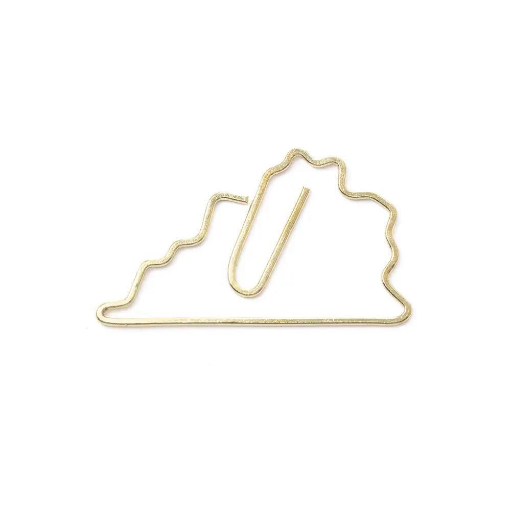 Gold paper clip shaped like the state of Virginia on a white background
