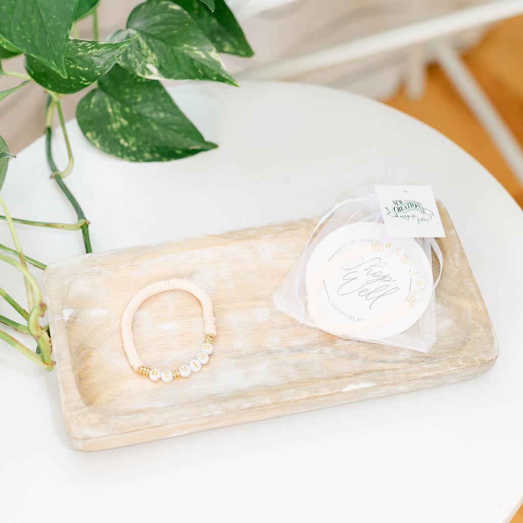 A pair of pink bracelets saying &