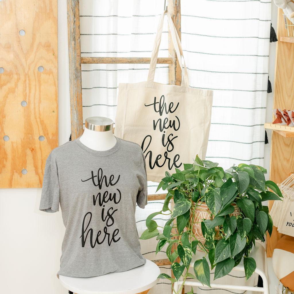 Gray t-shirt and beige tote bag with &