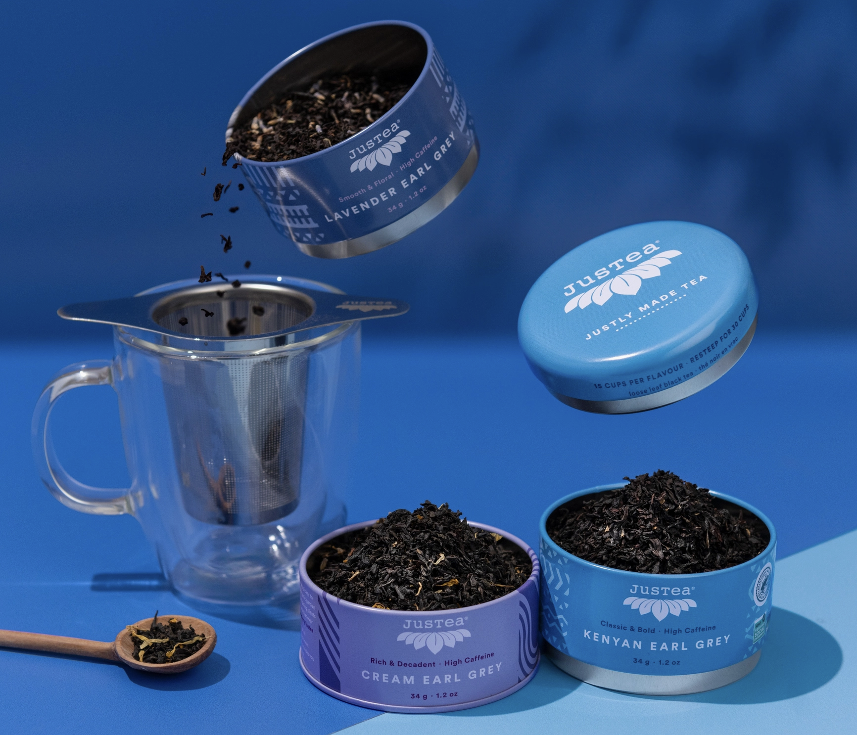 Multiple tins of Earl Grey tea set on a blue background