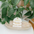 Set of two gold and pearl bracelets on a white card with &