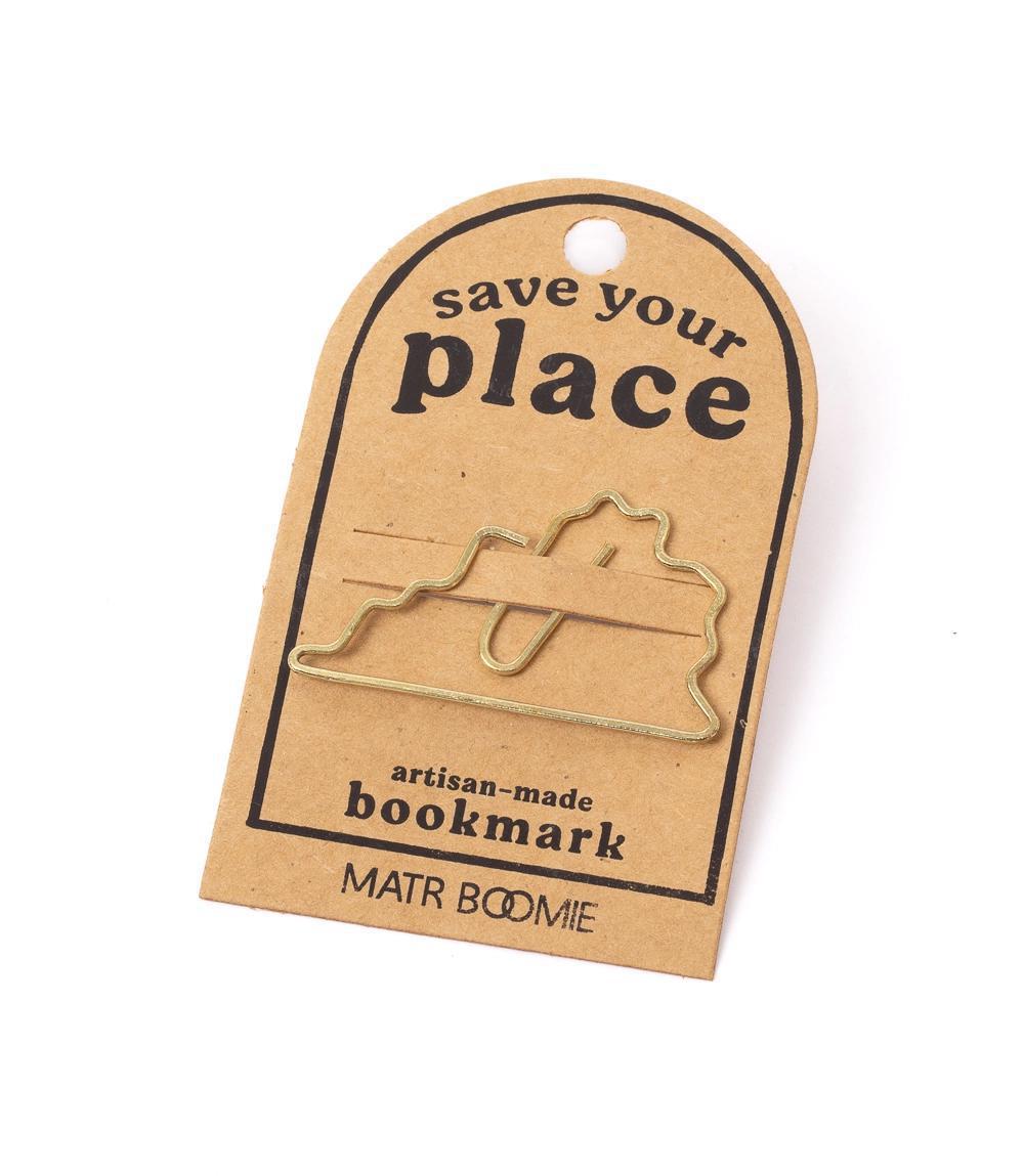 Gold bookmark shaped like a state on a brown card with &