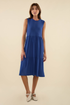 Woman wearing a blue dress on a beige background