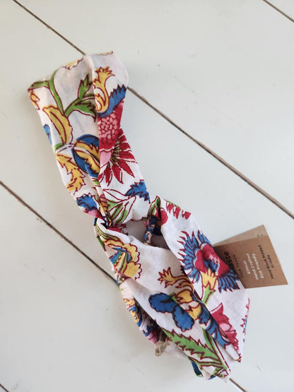 Colorful floral headband on a light wooden surface