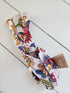 Colorful floral headband on a light wooden surface