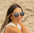 Woman wearing sunglasses on a sandy beach