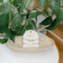 Set of two gold and pearl bracelets on a white card with &