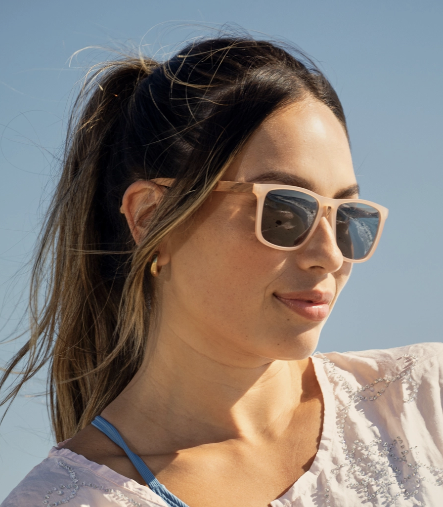 Woman wearing sunglasses with a clear blue sky background