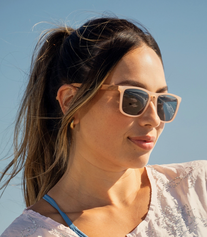 Woman wearing sunglasses with a clear blue sky background