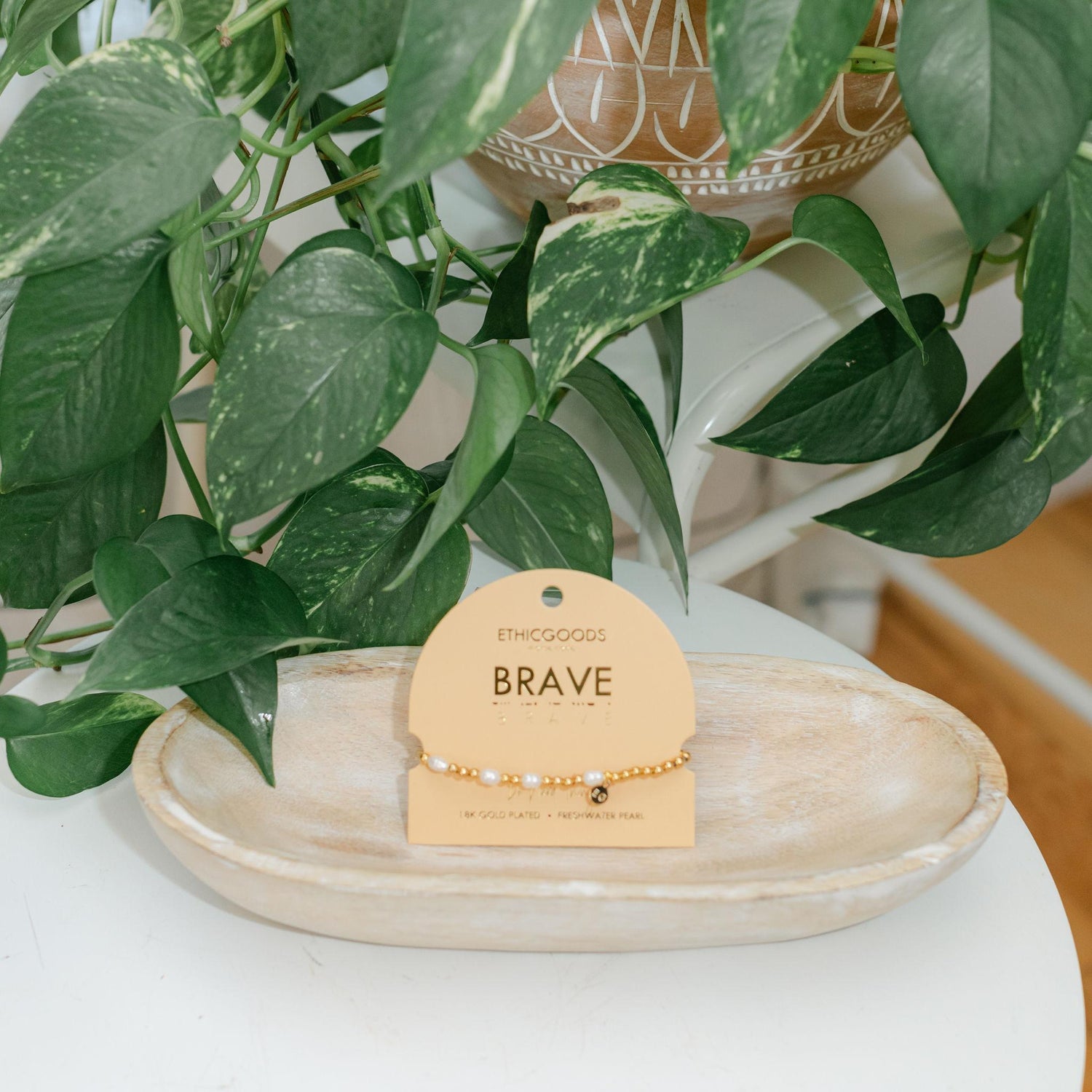 Bracelet on a peach card labeled &