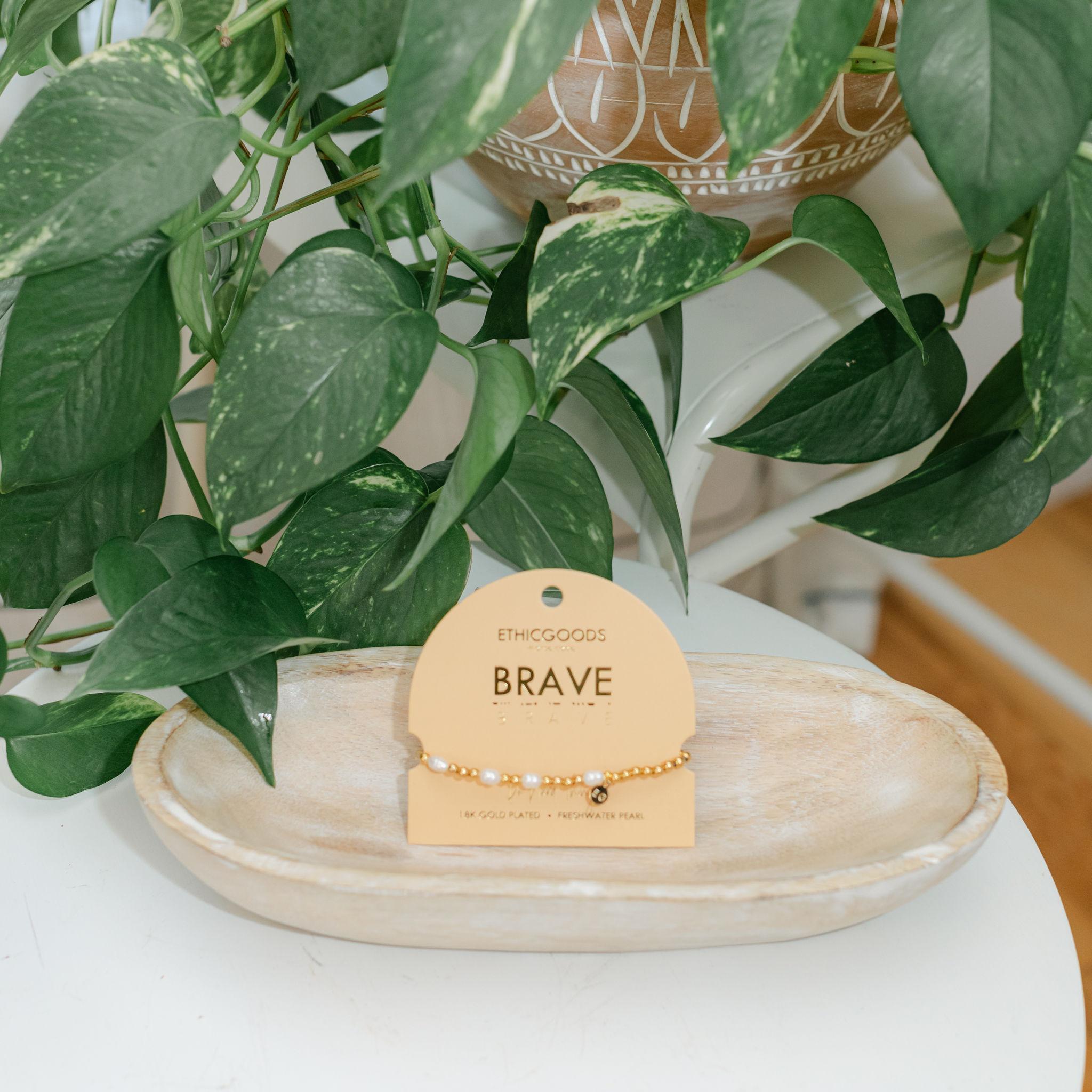 Bracelet on a peach card labeled &
