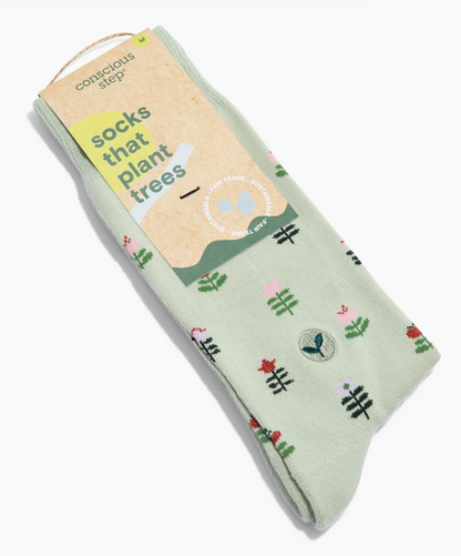 Light green socks with flowering plant design on a white background