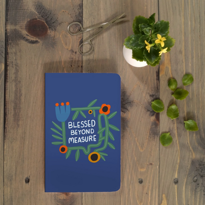 Blue notebook with floral design and text &