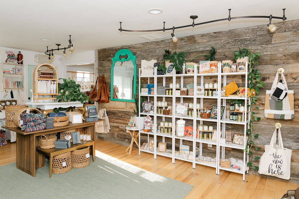 Store interior with shelves, products, and decor items on a wooden floor.