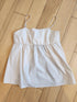 White top on a wooden floor