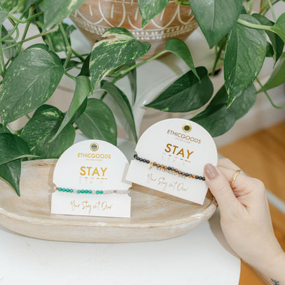 Two bracelets on white tags with &